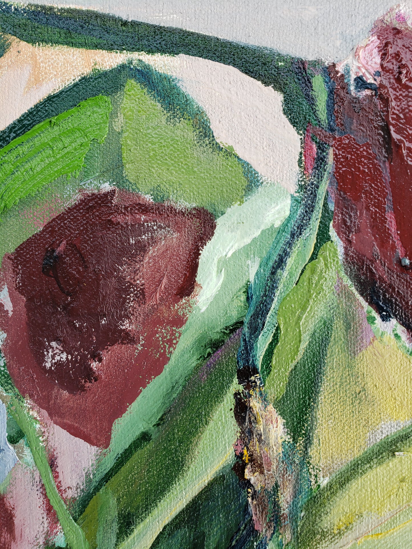 Close-up of a painting with red flowers and green leaves