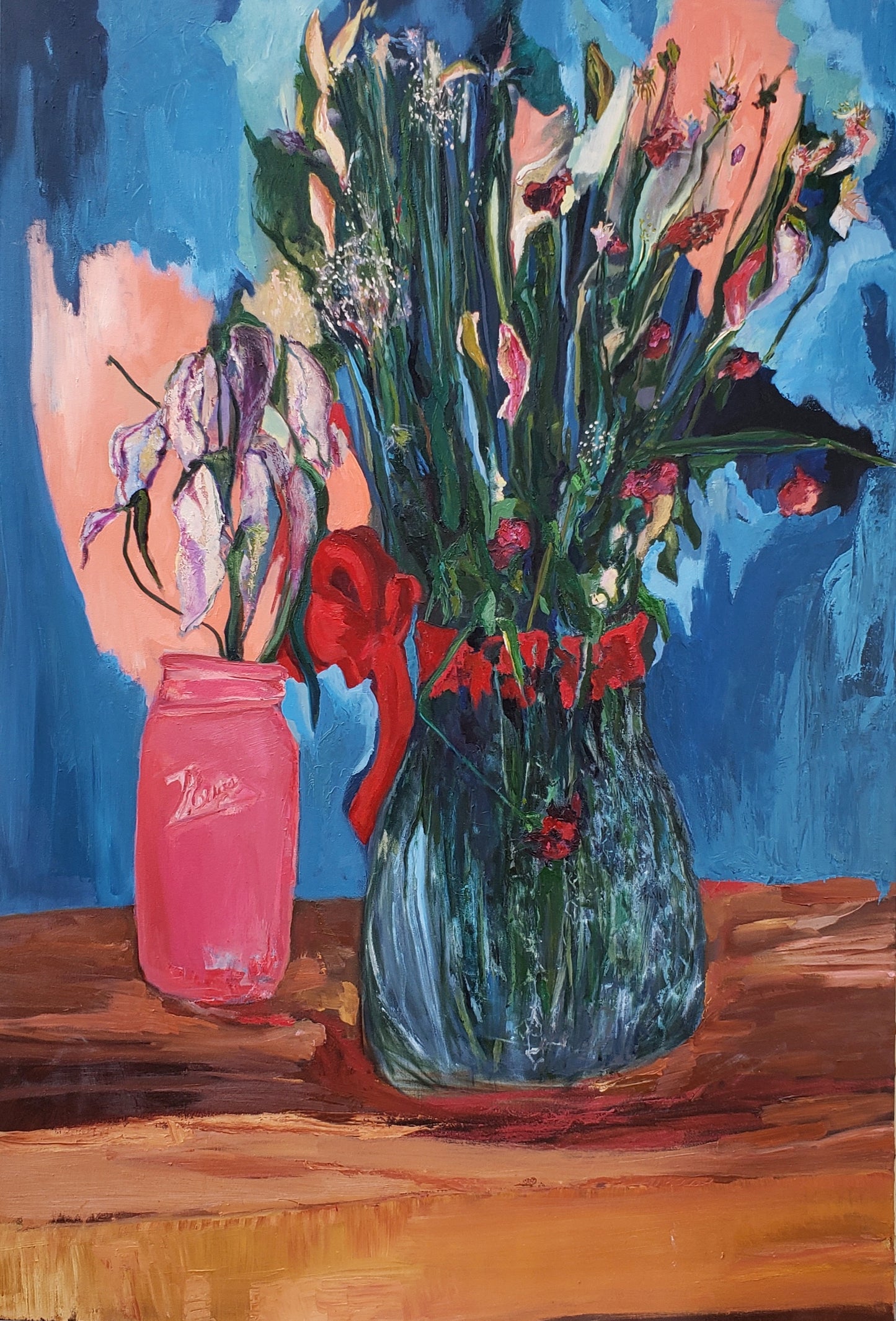 Oil painting of flowers in a pink jar and clear vase on a wooden surface with a blue background