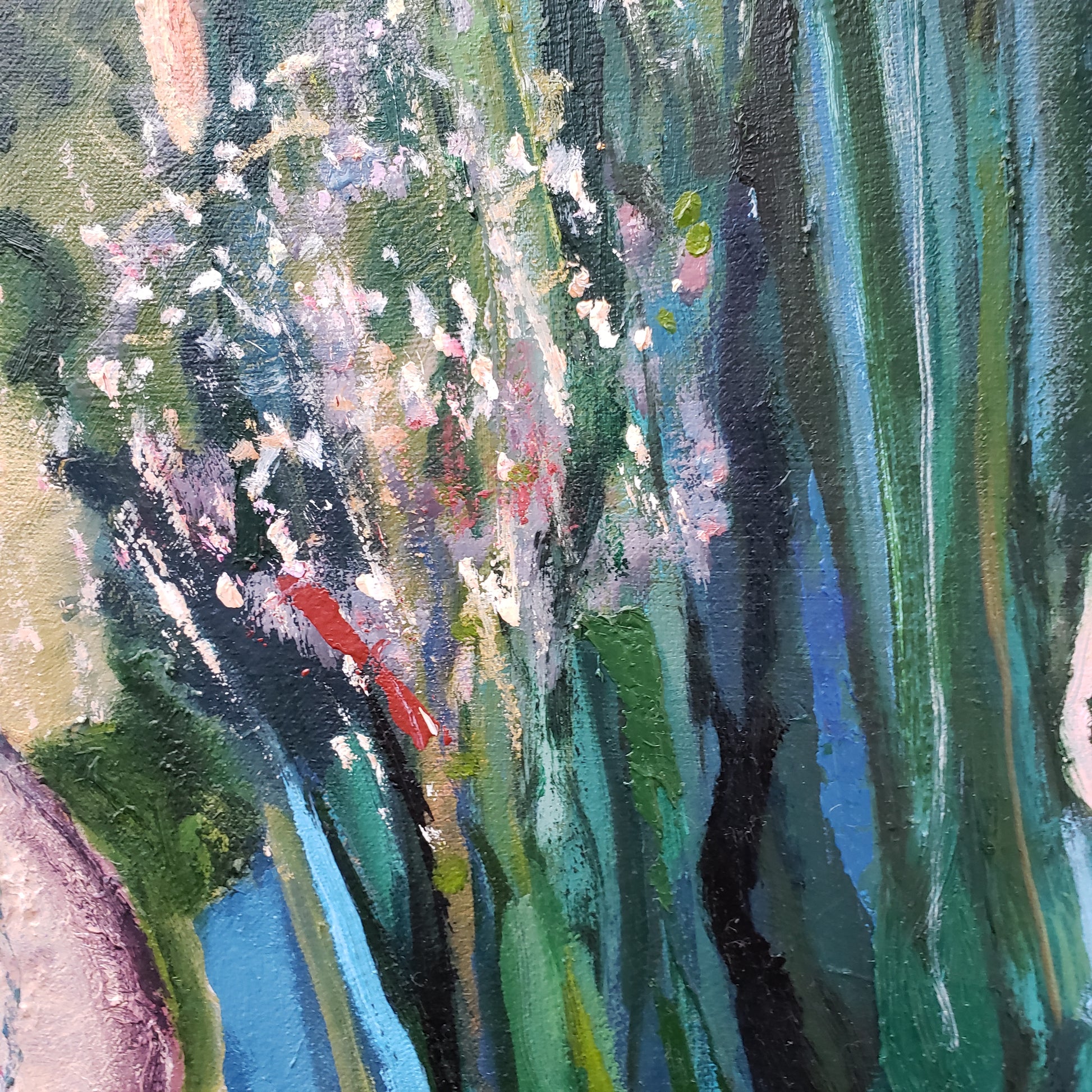 Close-up of an abstract oil painting with green, blue, and red flower hues.