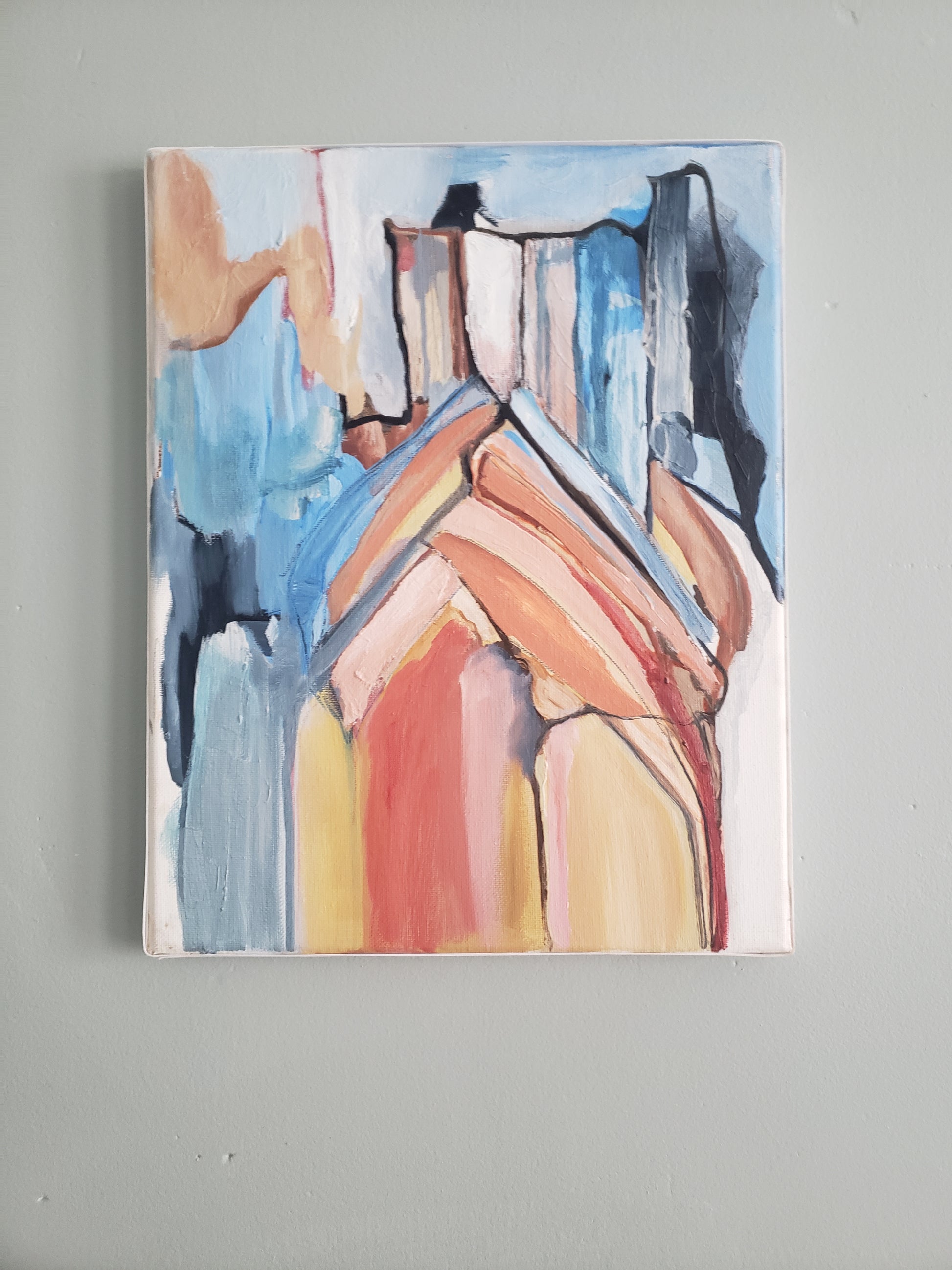 Abstract painting of the Notre Dame Cathedral hanging on a gray wall.