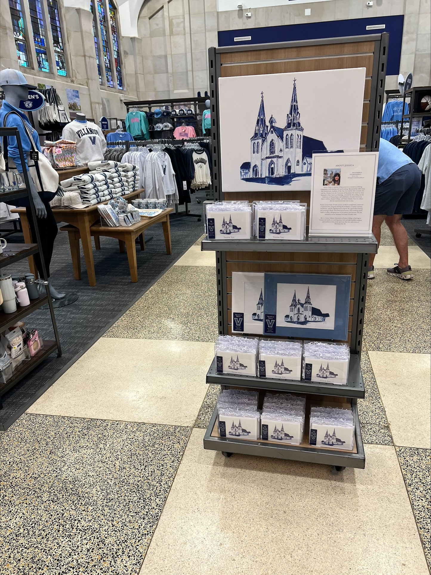 Display of Villanova University  prints and memorabilia in a store with a cathedral illustration.