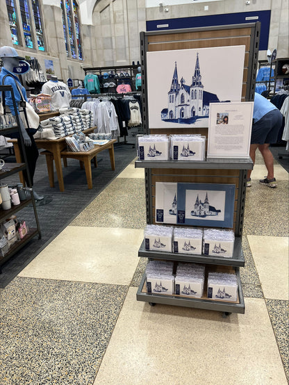 Display of Villanova University  prints and memorabilia in a store with a cathedral illustration.